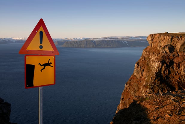 Warning sign cliff ahead, West fjords, Iceland